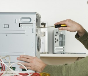 Technician performing computer service to a desktop Computer