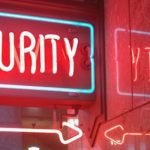 red glowing sign that says security for Cyber Security Month